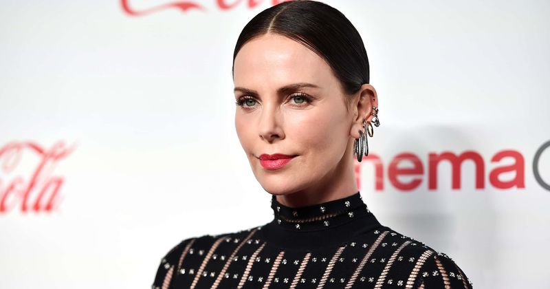 Charlize Theron schools French TV presenter on consent after he kisses interpreter without her permission