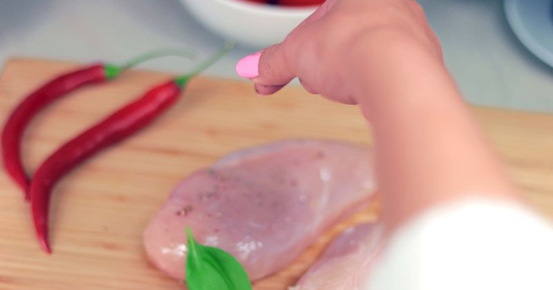 Don’t wash raw chicken before cooking because it spreads germs in the kitchen, warns CDC