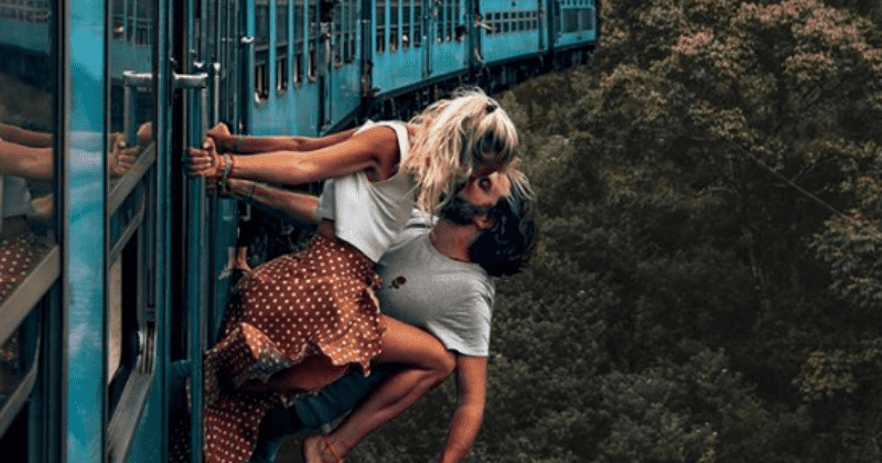 Couple slammed for sharing nerve-shredding photo showing them leaning out of moving train for 'wildest kiss'