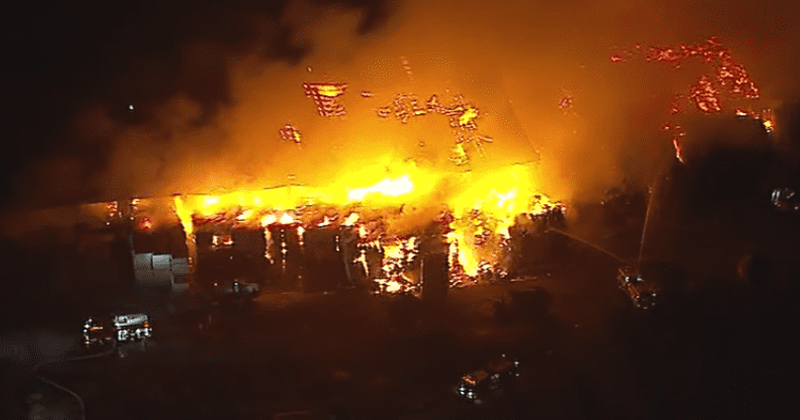 Fire crews battle massive hay fire blaze at a dairy farm in Chino