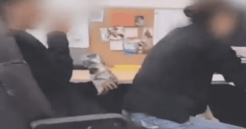 Female teacher's aide caught sitting on male high school student's lap, school starts investigation