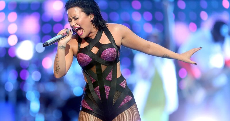 Demi Lovato pinches her 'extra fat' and talks about loving her cellulite