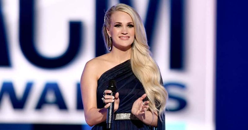 Carrie Underwood announces her upcoming performance and says she's on the way to a full recovery