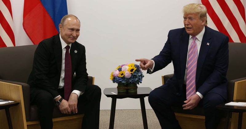 Donald Trump and Vladimir Putin share a smirk after US prez tells him 'please don't meddle in the elections', slams fake news media