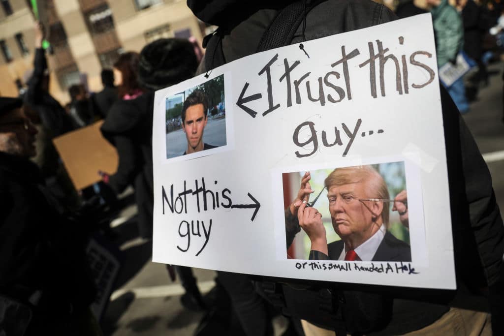A protester holding a sign of David Hogg and Donald Trump during March for Our Lives rally (Getty Images)
