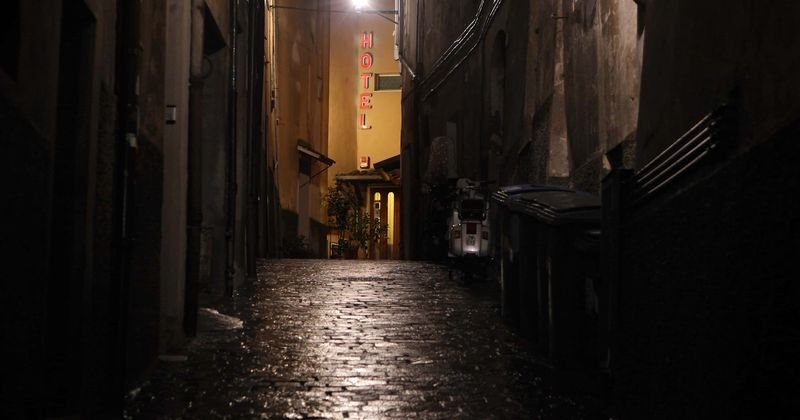 Horrific footage shows man walking through alley holding wife's decapitated head while smoking a cigarette
