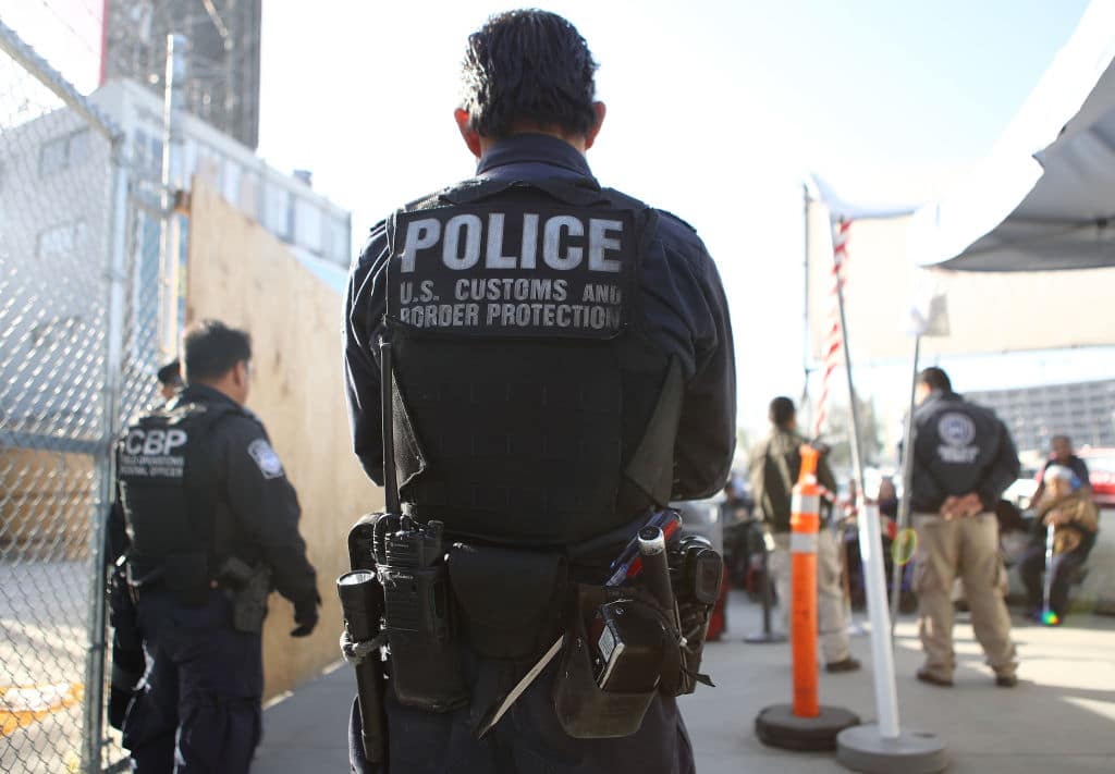 US Customs and Border Protection officer stands guard as pedestrians enter the United States at the San Ysidro port of entry on April 9, 2018 in San Ysidro, California. (Getty Images)