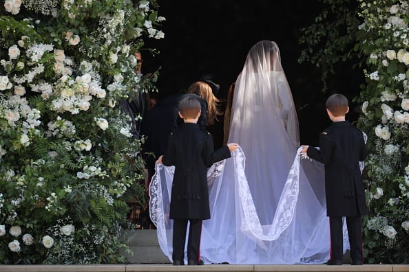 Made from silk threads and organza, the veil is five meters long and had to be held by two pageboys as Markle arrived. (Getty Images)