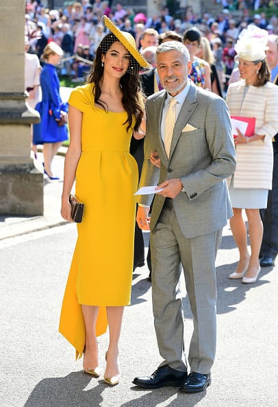 Actor George Clooney and his wife British lawyer Amal Clooney who looked stunning in a slim cut, mustard yellow dress (Getty Images)