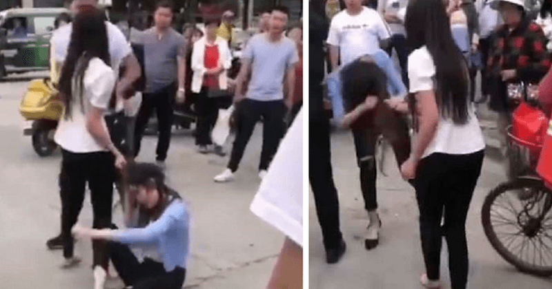 Shocking video footage shows woman dragging husband's mistress across the street by her hair, as onlookers egg her on