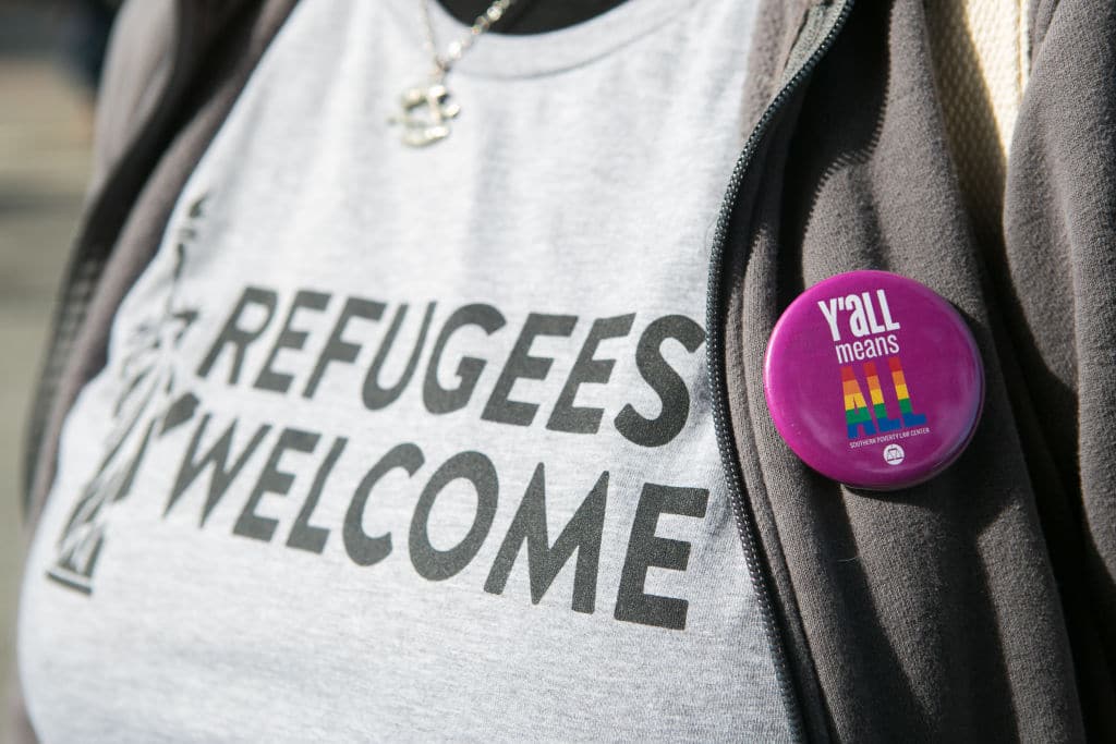 'Y'all Means All' button on a protestors shirt during an Interfaith Rally for Muslims and Refugees at the Lutheran Church of the Redeemer on February 4, 2017 in Atlanta, Georgia. (Getty Images)