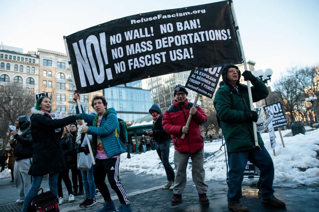 Demonstrators hold up a banner during a protest of President Donald Trump's proposed travel ban and suspension of the country's refugee program, March 16, 2017 in New York City. (Getty Images)