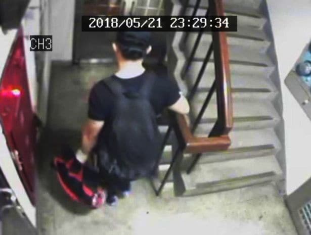 The suspect Gary Chu carrying garbage bags from his flat (Source: Asiawire)