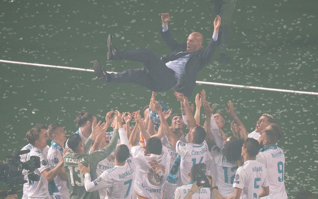 Zinedine Zidane, Manager of Real Madrid is thrown in the air by his players during celebrations at the Santiago Bernabeu stadium following their victory last night in Kiev in the UEFA Champions League final, on May 27, 2018, in Madrid, Spain. Real beat Liverpool 3-1 in the final to lift the European Cup and Champions League for the 13th time. (Photo by Denis Doyle/Getty Images)