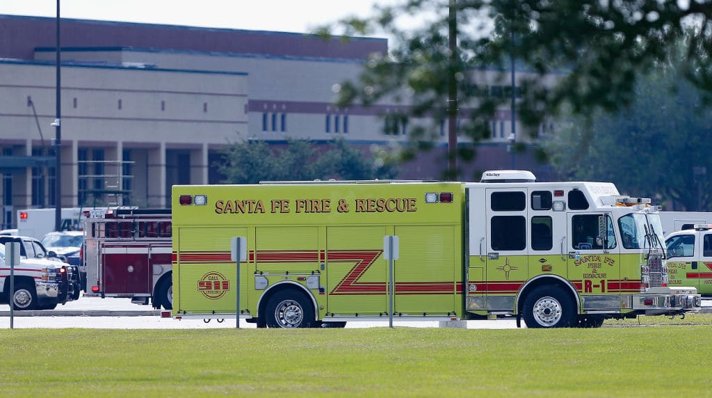 Emergency crews stage in the parking lot of Santa Fe High School where at least 10 students were killed on May 18, 2018, in Santa Fe, Texas. At least 10 people were killed when a gunman opened fire at Santa Fe High school. (Photo by Bob Levey/Getty Images)