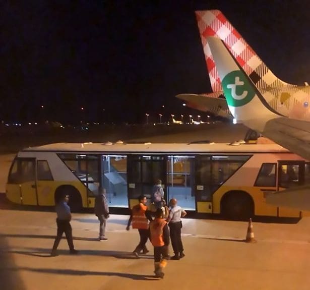 The man was escorted off the plane by medical staff and placed on an airport bus (Pinterest)