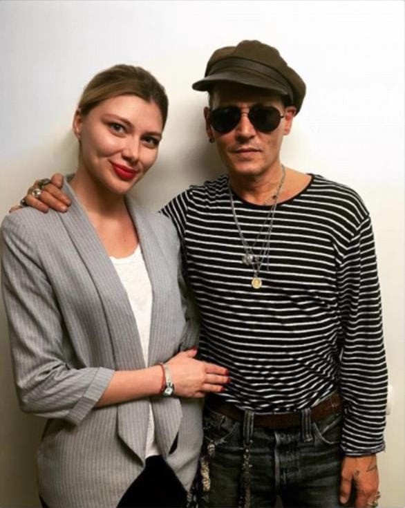 Depp is pictured with the staff at State Museum of Mayakovsky in Moscow (Instagram)