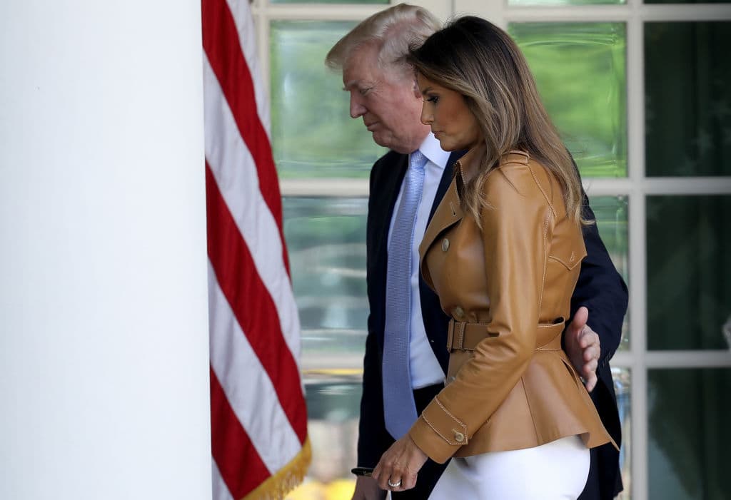 U.S. President Donald Trump escorts U.S. first lady Melania Trump after she spoke in the Rose Garden of the White House May 7, 2018 in Washington, DC. (Getty Images)