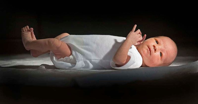 Father kisses his newborn on the forehead before abandoning it in a church
