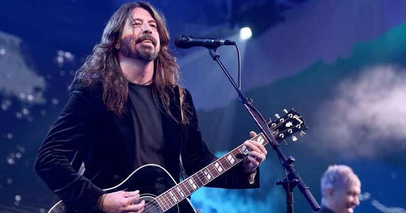 Dave Grohl of Foo Fighters prank fans with false stage fall.