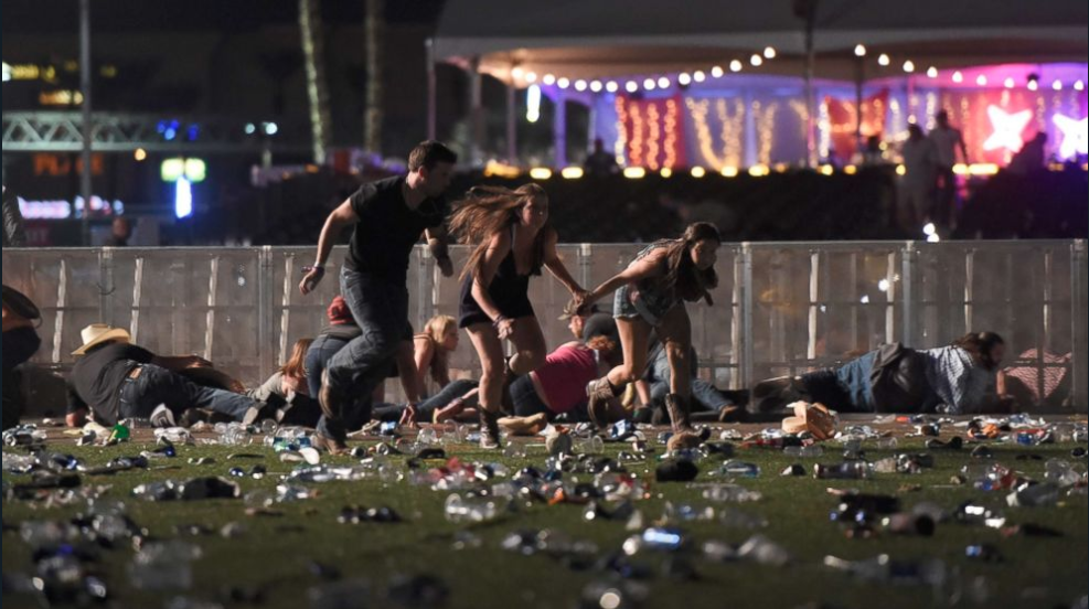 People running to safety as gunfire from the Mandalay Bay hotel ensues. (Getty Images)
