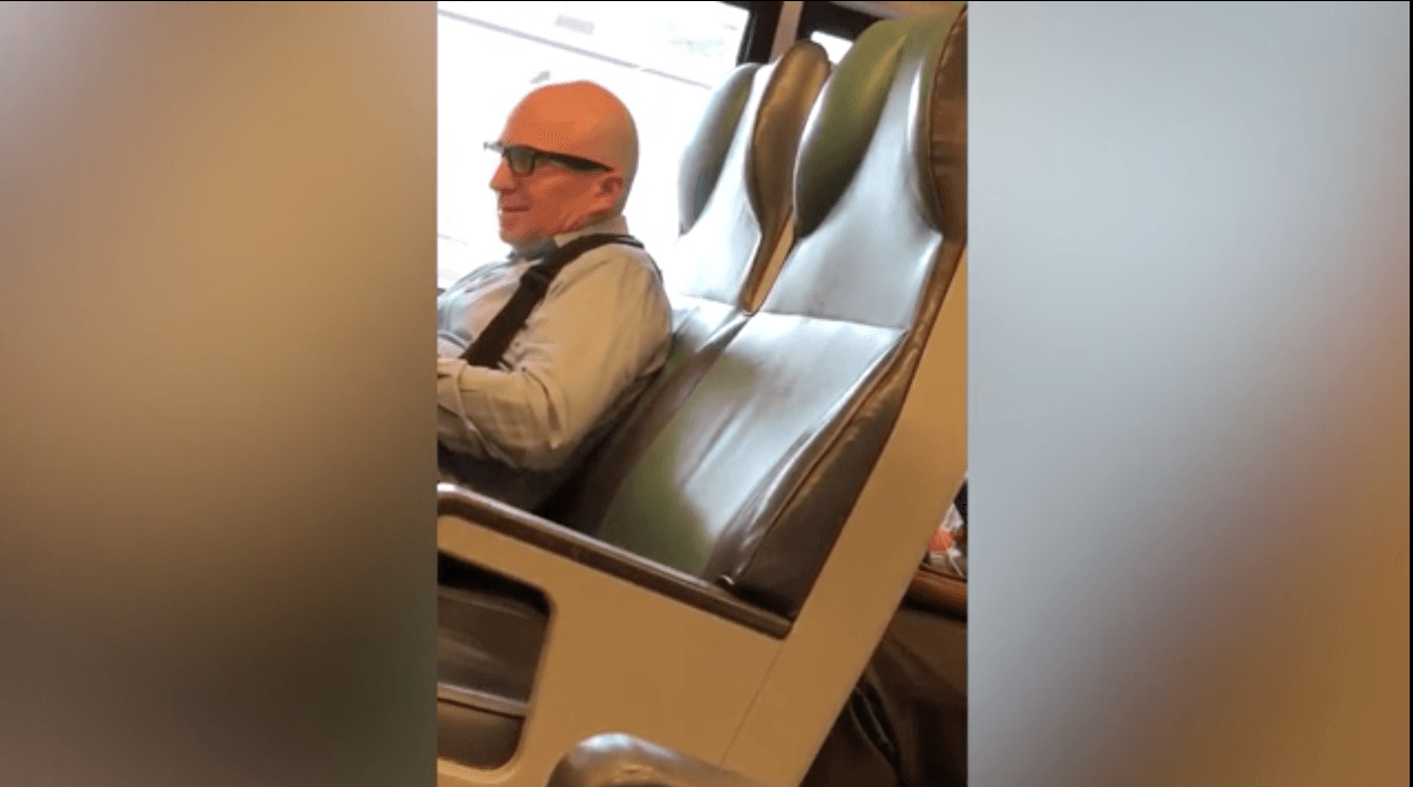 The man momentarily smiles after giving a death threat to the person over the other end of the phone and terminating the call. (Twitter)