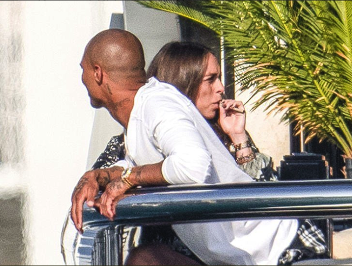 The picture shows the couple on vacation in Monaco and Green can be spotted with a vape pen blowing out smoke in the air. (Twitter)