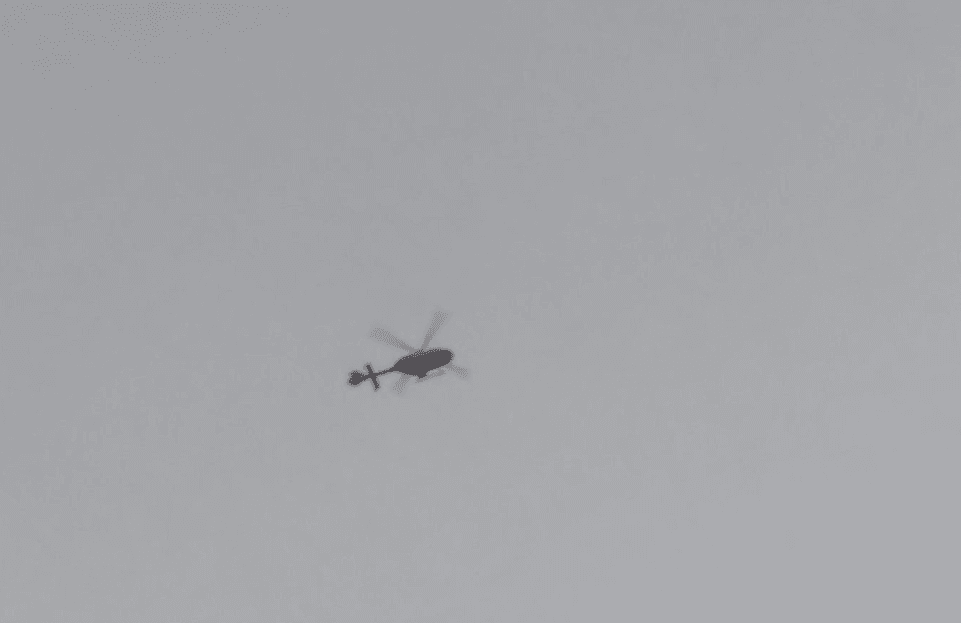 A police helicopter circles overhead (Twitter)