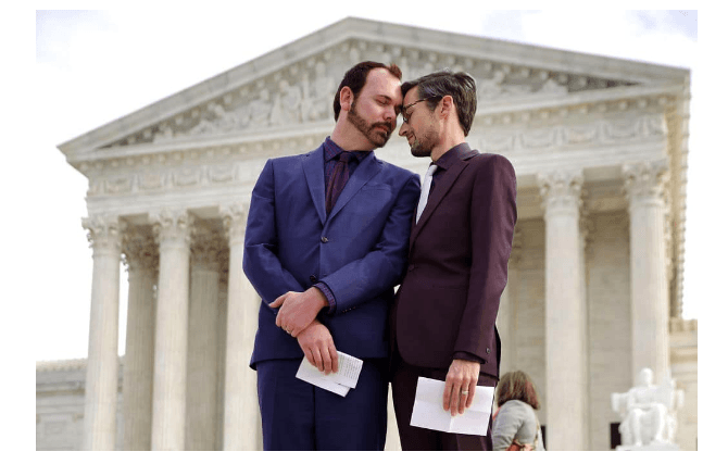 David Mullins (L) and Charlie Craig wait to speak to journalists after the U.S. Supreme Court hear the case Masterpiece Cakeshop v. Colorado Civil Rights Commission. (Getty Images)