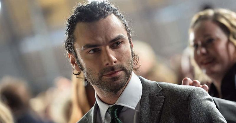 Poldark star Aidan Turner covers his body after saying he has had enough of shirtless scenes