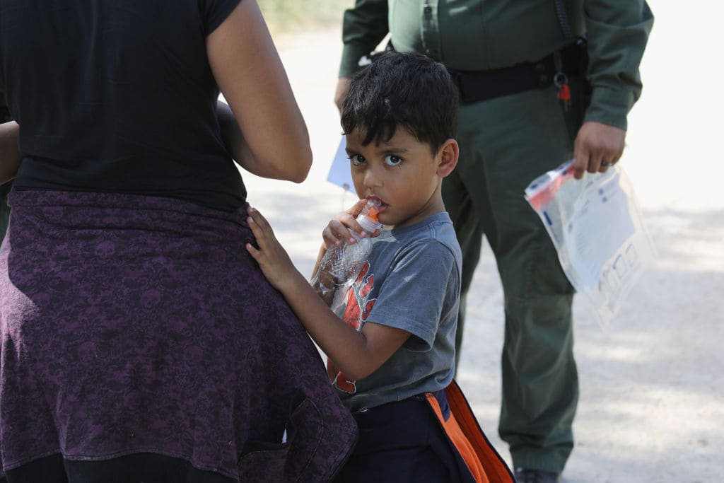 Central American asylum seekers wait as U.S. Border Patrol agents take them into custody on June 12, 2018, near McAllen, Texas. (Photo by John Moore/Getty Images)