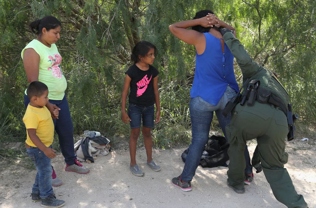 Central American asylum seekers are taken into custody by U.S. Border Patrol agents on June 12, 2018, near McAllen, Texas. (Photo by John Moore/Getty Images)