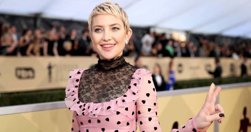 Kate Hudson shows off her growing baby bump in a vibrant yellow bikini