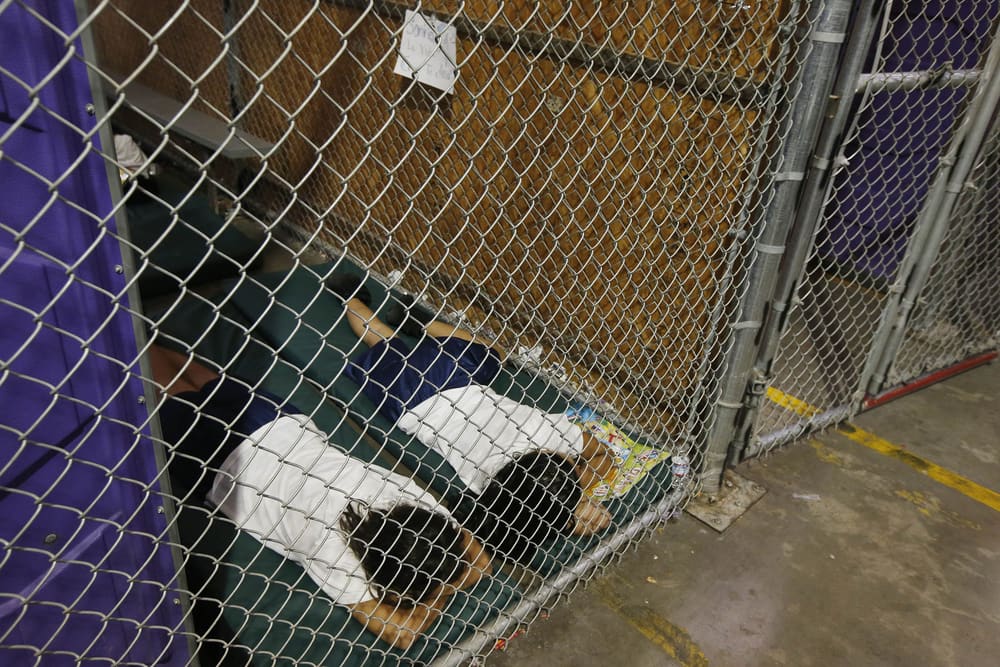Two female detainees sleep in a holding cell, as the children are separated by age group and gender, as hundreds of mostly Central American immigrant children are being processed and held at the U.S. Customs and Border Protection Nogales Placement Center on June 18, 2014, in Nogales, Arizona. (Photo by Ross D. Franklin-Pool/Getty Images)