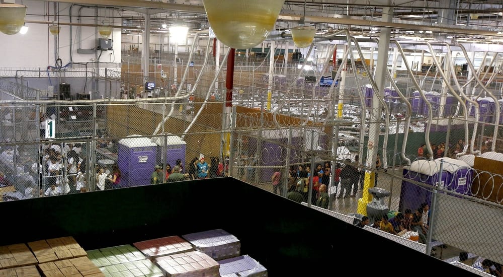 Hundreds of mostly Central American immigrant children are separated into age and gender holding areas as they are being processed and held at the US Customs and Border Protection Nogales Placement Center on June 18, 2014, in Nogales, Arizona (Photo by Ross D. Franklin-Pool/Getty Images)