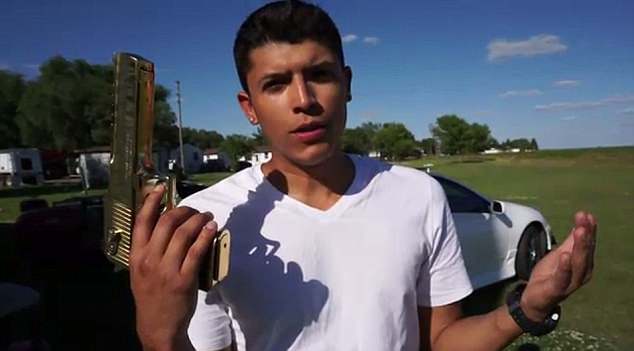 Ruiz shows off the gold-plated .50-caliber Desert Eagle handgun moments before the stunt. (Screengrab)