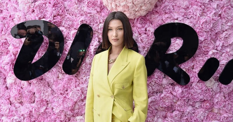 Bella Hadid stuns in a lemon pantsuit as she brushes off a nip slip at Dior show