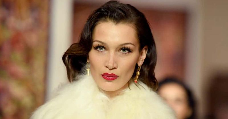 Bella Hadid stuns in a lemon pantsuit as she brushes off a nip slip at Dior show