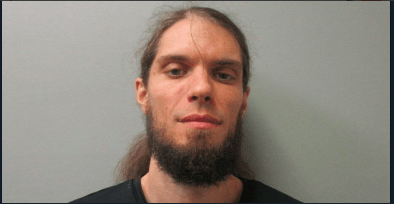 Shane Sealy, 34, was charged with menacing and reckless endangerment after he brandished a handgun at an immigration rally. (Twitter)