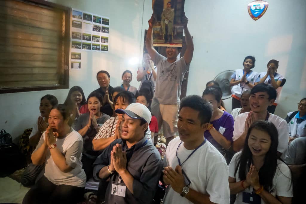 Relatives of the missing boys pray for them after the 12 boys and their soccer coach have been found alive in the cave where they've been missing for over a week after monsoon rains blocked the main entrance on July 02, 2018 in Chiang Rai, Thailand. (Photo by Linh Pham/Getty Images)
