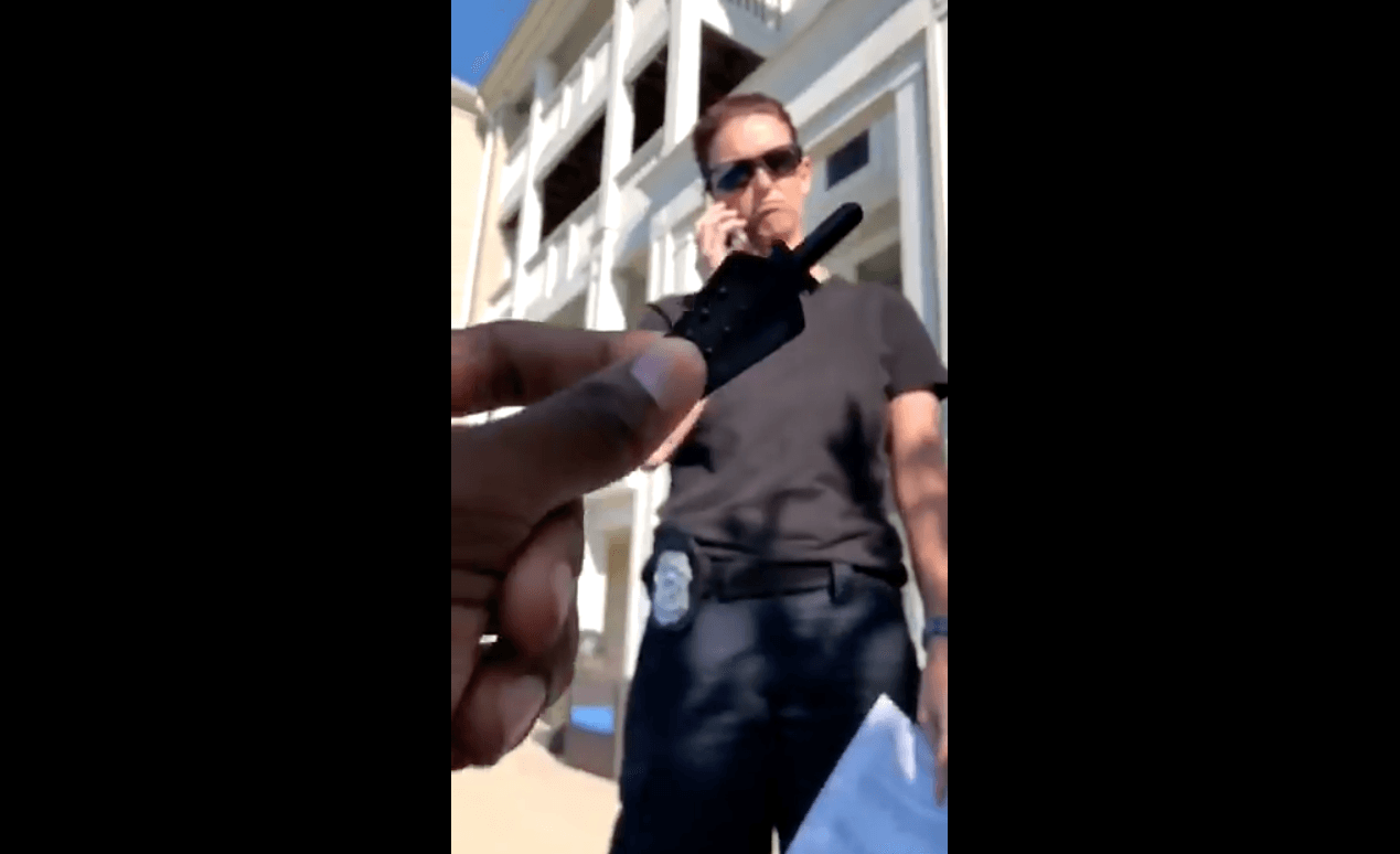 Holland showing the security guard his key to the his apartment in the complex. (Twitter)