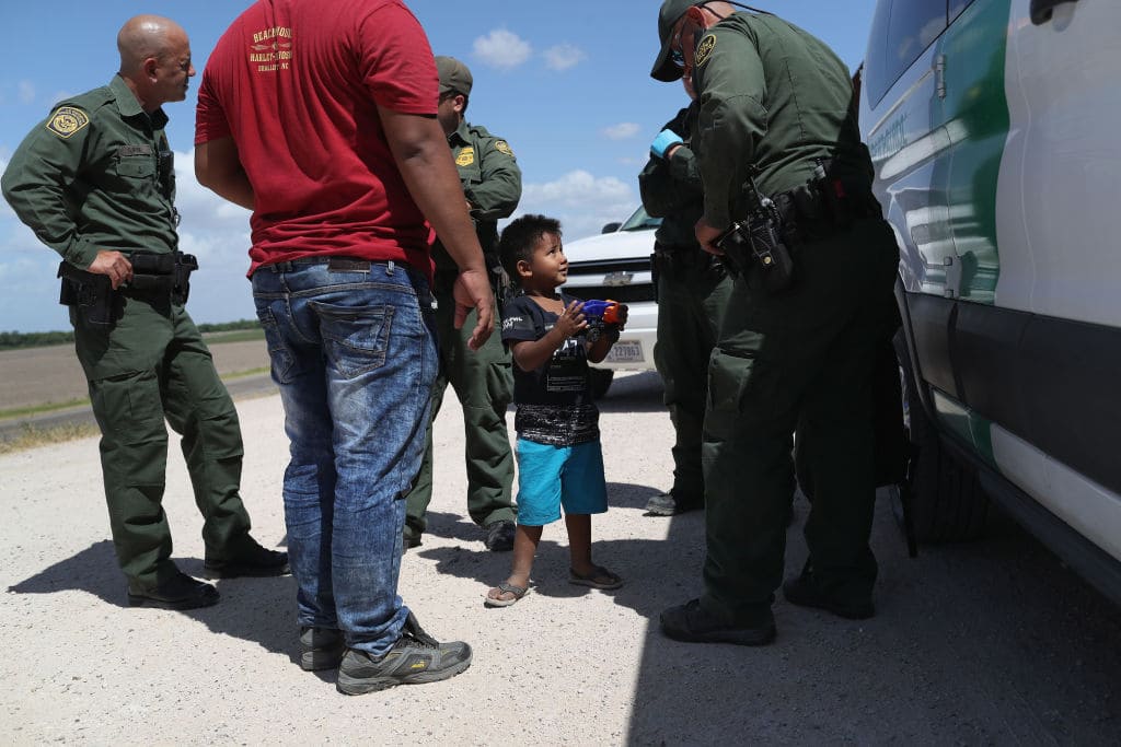 A boy and father from Honduras are taken into custody by U.S. Border Patrol agents near the U.S.-Mexico Border on June 12, 2018 near Mission, Texas. (Getty Images)