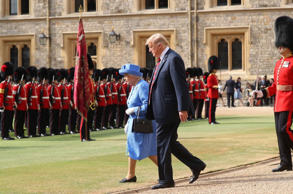 U.S. President Donald Trump and Britain's Queen Elizabeth II inspect a Guard of Honour, formed of the Coldstream Guards at Windsor Castle on July 13, 2018 in Windsor, England. (Getty Images)