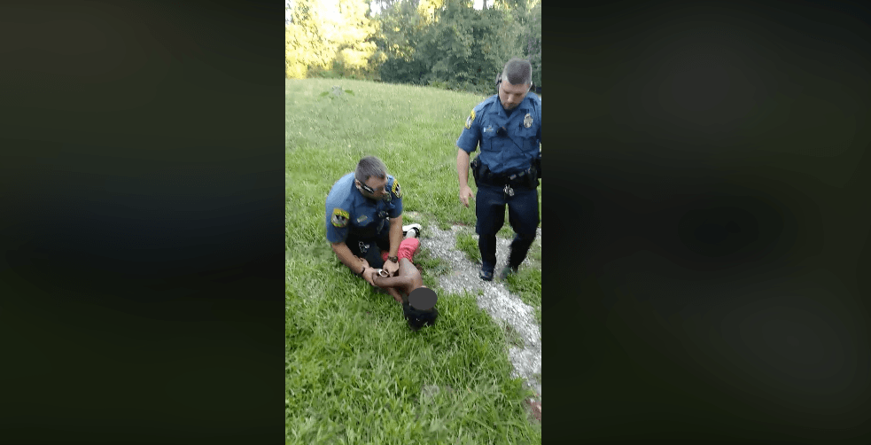 A cop can be seen twisting the 10-year-old's arms in an effort to "calm him down" (Facebook/Ariel Collins)
