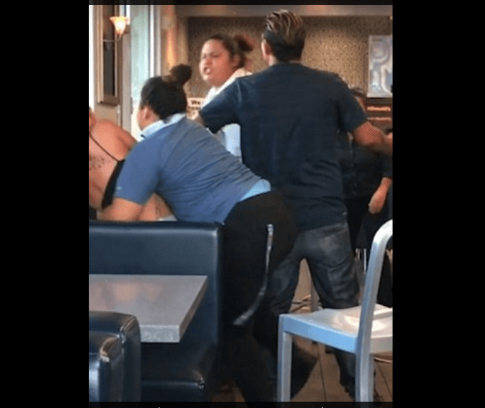Customers and employee at the eatery can be seen breaking up the brawl. (Youtube screenshot)