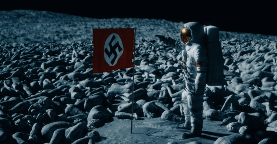 Jack's hallucinations culminate in a scene depicting an astronaut placing the Nazi flag on the moon. (Image Source: CBS All Access/ Strange Angel)