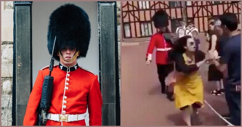 Royal guard outside Windsor Castle "loses cool," shoves female tourist standing in his way