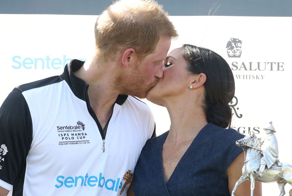 Meghan Duchess of Sussex and Prince Harry Duke of Sussex kiss after posing with the trophy after the Sentebale Polo 2018 held at the Royal County of Berkshire Polo Club on July 26, 2018 in Windsor, England. (Photo by Chris Jackson/Getty Images)