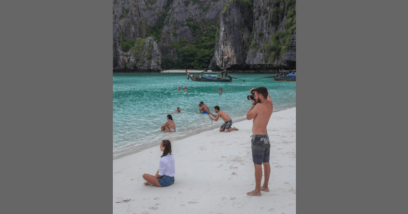 Man goes to take a photo of his girlfriend on the beach, stops, looks around, then takes the most IRONIC pic ever!