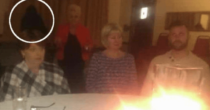 Black hooded 'ghost' caught in the middle of a pub seance spooks British revelers